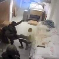 An IDF soldier kicks a Palestinian in the West Bank town of Dura in October 2025. (Screen capture/X)